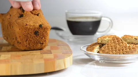 Hands cut cake with raisin on a chopping board a sharp knife Stock Footage 79347163