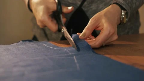 Hands cut the fabric with tailor's scissors, cutting a piece of fabric the 動画素材 152098046
