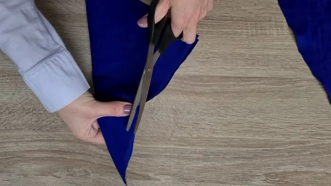 Hands Cut The Fabric With Tailor's Scissors, Cutting A Piece Of Fabric  Stock Footage 154896420