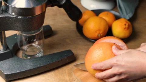 Hands cut grapefruit for making freshly squeezed juice. selective focus Stock Footage 235781495