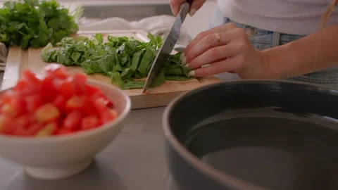 Hands cut lettuce on cutting board in kitchen, chop, cooking food Stock Footage 220754202