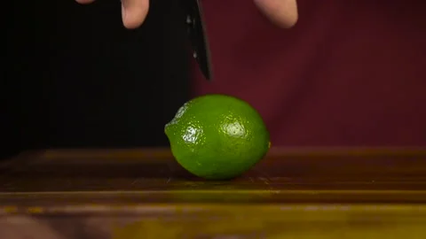 Hands Cut Lime with a Knife Stock Footage 243605405