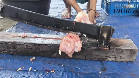 Hands cut meat with a heavy meat cutter Stock Footage 339754847