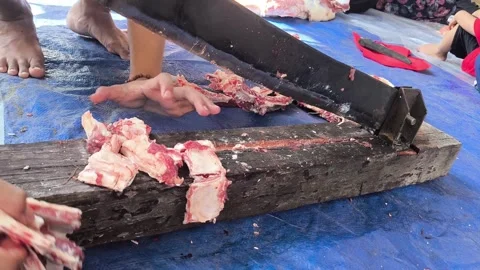 Hands cut meat with a heavy meat cutter Stock Footage 340142702
