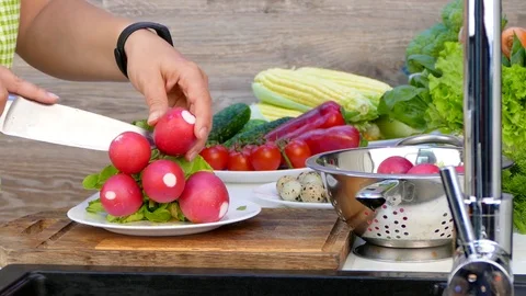 Hands cut off the ponytail from the radish Stock Footage 84448999