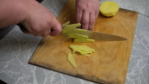 Hands cut potatoes with a knife Stock Footage 122762572