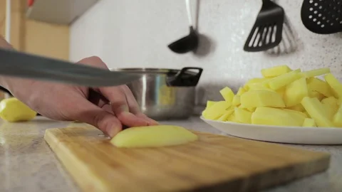 Hands cut potatoes in small slices close up Video stock 127892640