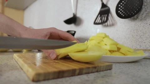 Hands cut potatoes in small slices close up Video stock 127892807