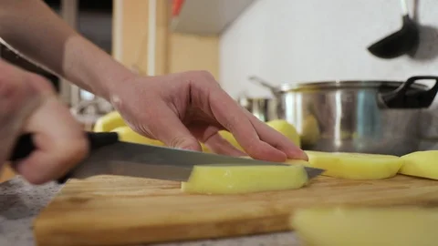Hands cut potatoes in small slices close up Video stock 127892950