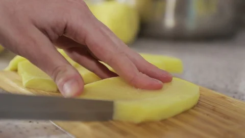Hands cut potatoes in small slices close up Video stock 127893018