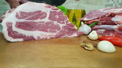 Hands cut raw meat in the kitchen Video stock 83476286