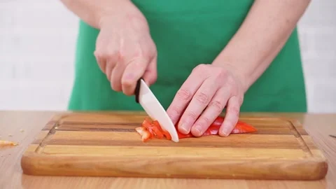 Hands cut red pepper on a cutting board. Stock Footage 170078374