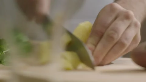 Hands cuts potatoes into small pieces on the table Stock Footage 198937291