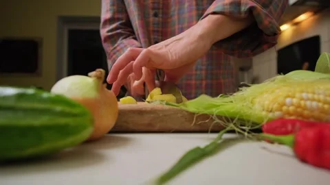 Hands cuts potatoes on the table at authentic kitchen. Time lapse Stock Footage 316952160