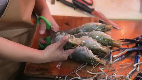 Hands Cutting and Preparing Large Fresh River Prawns with Scissors on Wooden Boa Stock Footage 344217109