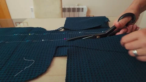 Hands Cutting Blue Textured Fabric for Sewing Project with Large Tailor Scissors Stock Footage 346410561