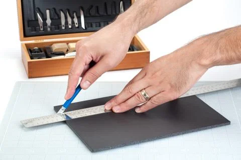 Hands cutting on board with sharp knife Stock Photos