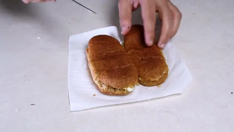 Hands Cutting Brown Bread Roll Stock Footage 342607270
