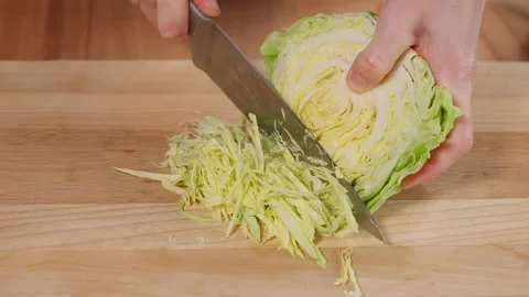 Hands cutting cabbage into strips Stock Footage 253548736