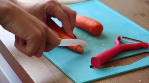 Hands cutting carrots in pieces Stock Footage 62528831