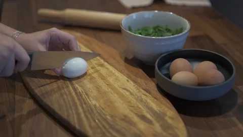Hands cutting egg Stock Footage 127695216