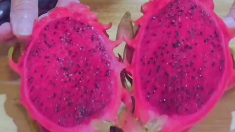 Hands Cutting Fresh Dragon Fruit on Wooden Board Stock Footage 345102374