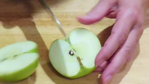 Hands Cutting Fresh Green Apple on Wooden Board Stock Footage 345102350