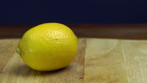 Hands Cutting Fresh Lemon with Knife on Chopping Board, Slider Video stock 76521229