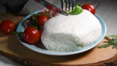 The hands cutting a fresh mozzarella cheese, food made in Puglia Stock Footage 131556893