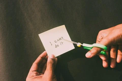 Hands cutting letter T with scissors with written text i can't do it. Busines Stock Photos