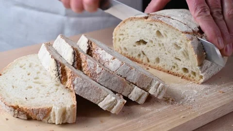 Hands cutting organic sourdough bread with type 0 wheat flour. Stock Footage 146949722