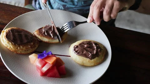 Hands cutting a pancake with a knife. Stock Footage 273033831