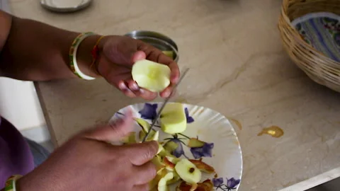 Hands Cutting Peeled Apple with Knife During Healthy Food Preparation Stock Footage 337729848
