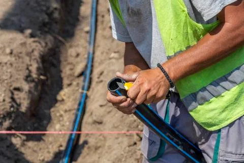 Hands cutting polypropylene pipe Stock Photos