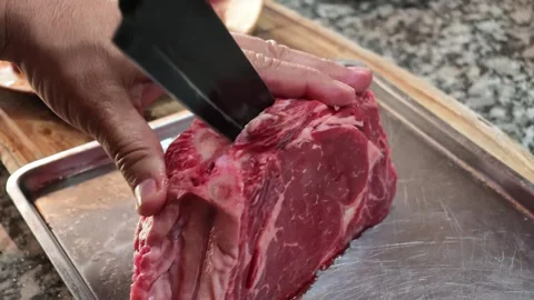 Hands Cutting Raw Beef for Traditional Argentine Asado Stock Footage 343882265
