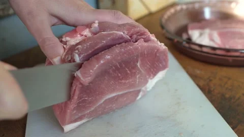 Hands cutting raw meat close up Stock Footage 144457840