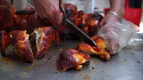 Hands cutting roast chicken with scissors Stock Footage 141964745