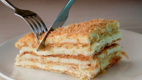 Hands cutting a slice of cake with a knife and fork. 動画素材 333053949