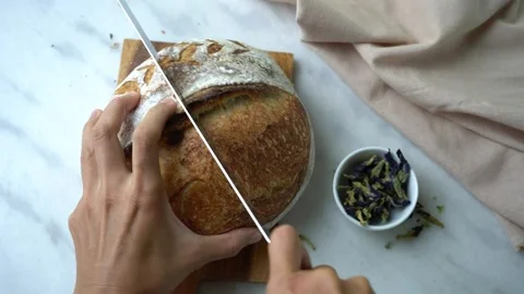 Hands Cutting Slice Of Sourdough Bread Close-Up Stock Footage 201524486