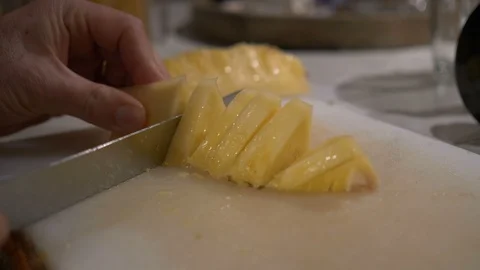 Hands cutting slices of pineapple Stock Footage 87730287