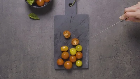 Hands Cutting tomatoes on a cutting board Stock Footage 124585095