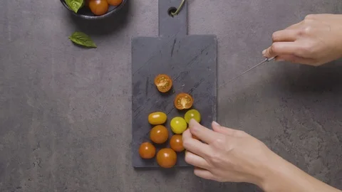 Hands Cutting tomatoes on a cutting board Stock Footage 124585346