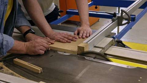 Hands Cutting Wood on Table Saw in Workshop Stock Footage 337549635