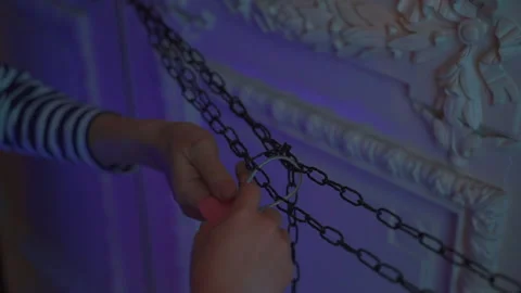 Hands in a dark room close the lock on the chain Stock Footage 196180654