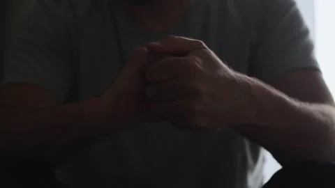Hands in a dark setting reveal a man's s... | Stock Video | Pond5