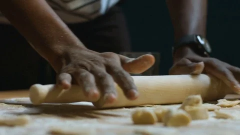 Hands of dark skinned man working with dough and rolling pin Stock Footage 83853274
