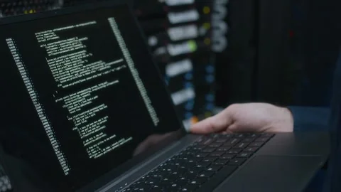 Hands of Data Center Specialist Holding Laptop with Running Program Code Stock Footage 303554857