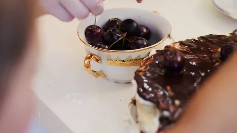 Hands decorate cake with cherries Stock Footage 78362276