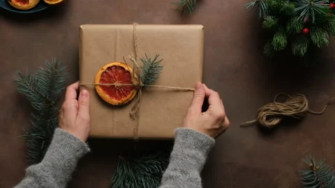 Hands decorates Christmas gift box with dried grapefruit. Stock Footage 164292983