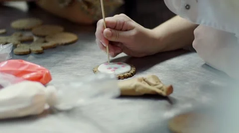 Hands Decorating christmas cookies with selective focus and place for text Stock Footage 57498066